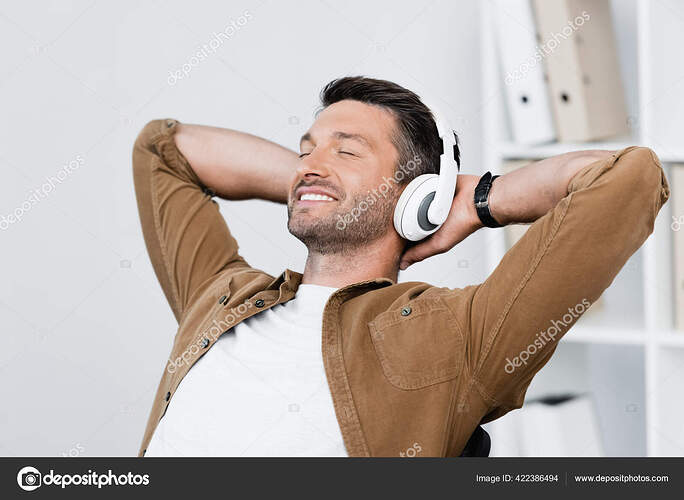 depositphotos_422386494-stock-photo-smiling-businessman-headphones-relaxing-while