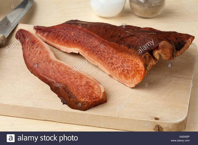 fresh-slice-of-a-beefsteak-fungus-on-a-cutting-board-XAEM2P