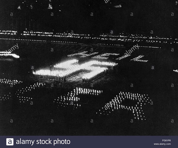 nazi-rally-c1937-nmembers-of-the-nazi-party-holding-torches-standing-FG01P8