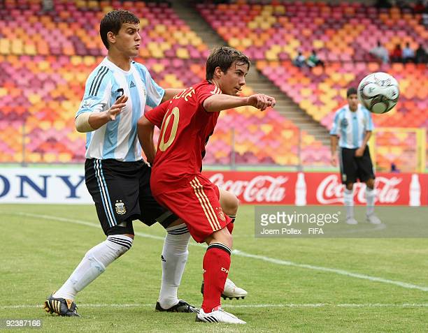 mario-goetze-of-germany-and-leandro-gonzalez-pirez-of-argentina-for-picture-id92387166